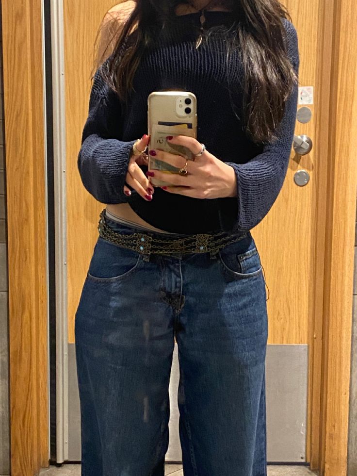 Posing a modern girl wearing blue knitted top and blue jeans